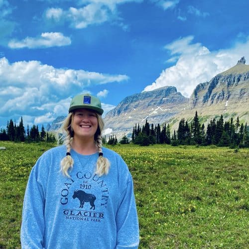 Academy at SOAR humanities teacher standing in front of a mountain range.